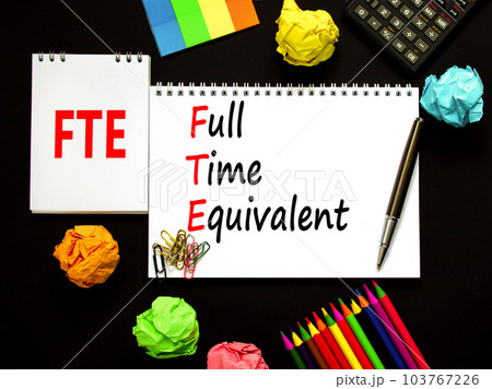 FTE Full time equivalent symbol. Concept words FTE Full time equivalent on beautiful white note. Beautiful black background. Calculator. Business and FTE Full time equivalent concept. Copy space. 103767226