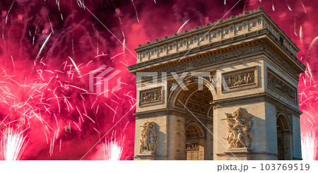 Celebratory colorful fireworks over the Arc de Triomphe, Paris, France. The walls of the arch are engraved with the names of 128 battles and names of 660 French military leaders (in French) Celebratory colorful fireworks over the Arc de Triomphe, Paris, France. The walls of the arch are engraved with the names of 128 battles and names of 660 French military leaders (in French) 103769519