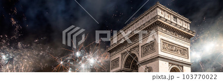 Celebratory colorful fireworks over the Arc de Triomphe, Paris, France. The walls of the arch are engraved with the names of 128 battles and names of 660 French military leaders (in French) 103770022