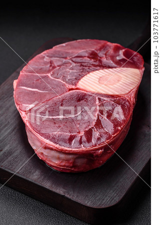 Fresh beef ossobuco steak with salt, spices and herbs 103771617