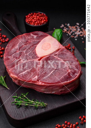 Fresh beef ossobuco steak with salt, spices and herbs 103771642