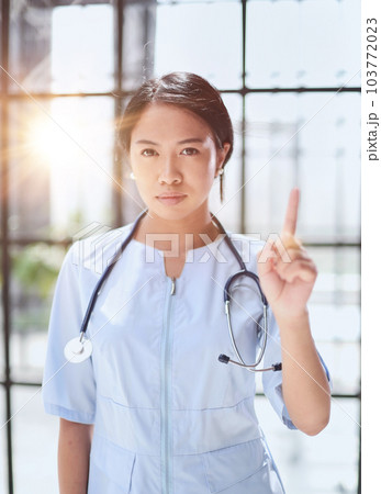 Portrait of asian female doctor showing thumbs up and smiling Portrait of asian female doctor showing thumbs up and smiling 103772023