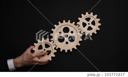 parts of a wooden mechanism on a black background parts of a wooden mechanism on a black background 103772837