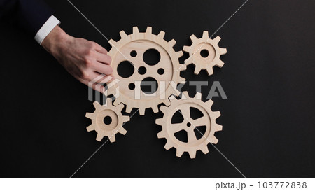 parts of a wooden mechanism on a black background parts of a wooden mechanism on a black background 103772838