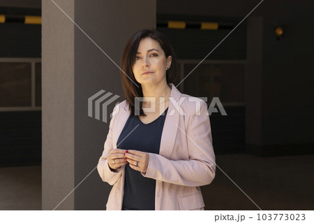 Portrait Confident Mature 40 yo Beautiful Woman, Professional Psychologist. Intelligent Caucasian Burnette Female With Brown Eyes Looks At Camera, Wears Pink Jackets, Blue Shirt. Horizontal Plane 103773023