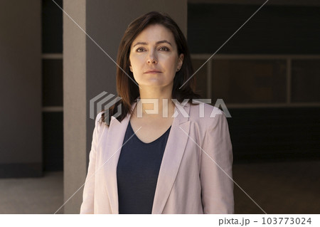 Portrait Confident Mature 40 yo Beautiful Woman, Professional. Intelligent Caucasian Burnette Female With Brown Eyes Looks At Camera, Wears Pink Jackets, Blue Shirt. Horizontal Plane Business Concept Portrait Confident Mature 40 yo Beautiful Woman, Professional. Intelligent Caucasian Burnette Female With Brown Eyes Looks At Camera, Wears Pink Jackets, Blue Shirt. Horizontal Plane Business Concept 103773024