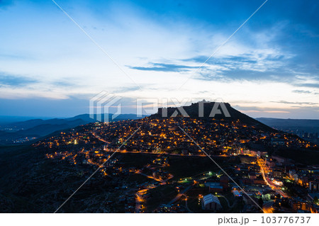 トルコ　マルディンのライトアップされた旧市街の夜景と山頂に立つマルディン城 103776737