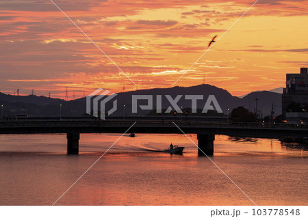 朝焼けの宍道湖に向かうシジミ漁の船 103778548