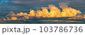 golden clouds after sunset on a dark blue sky 103786736