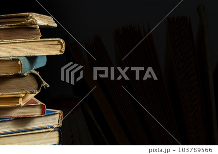 Stack of hardcover old books with on a dark background. Bookshelf shop, Knowledge publications, literature. Bookish bookstore bookstore Stack of hardcover old books with on a dark background. Bookshelf shop, Knowledge publications, literature. Bookish bookstore bookstore 103789566