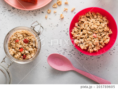 Jar of strawberry homemade granola, plate with yogurt and glass of milk. Jar of strawberry homemade granola, plate with yogurt and glass of milk. 103789605