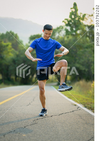 Full length of handsome sportsman warming up before running in the morning. Fitness, sport and healthy lifestyle concept 103792282