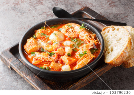 Mediterranean soup of seafood and white fish with shrimp, mussels, scallops, squid close-up in a bowl. horizontal 103796230