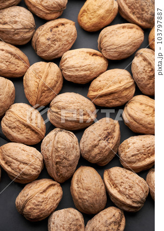 Whole walnuts nuts with shells close-up background studio shot Whole walnuts nuts with shells close-up background studio shot 103797887