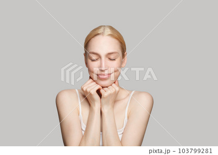 Happy woman enjoying and dreaming. Facial treatment, skincare and cosmetology concept 103799281
