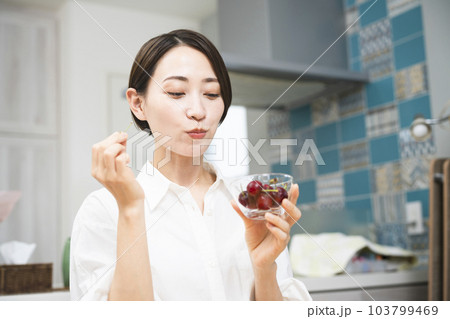 サクランボを食べる若い女性　飲食イメージ 103799469