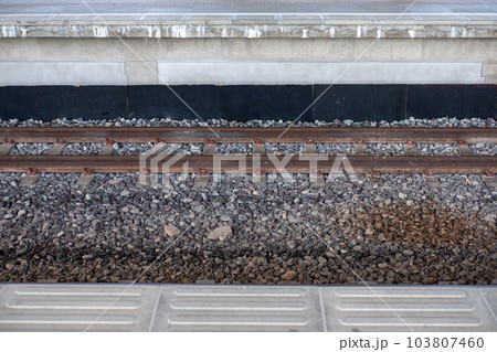 Gravel and train tracks at the train station Gravel and train tracks at the train station 103807460