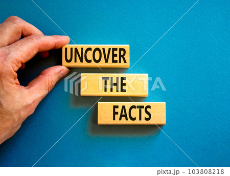 Uncover the facts symbol. Concept words Uncover the facts on wooden blocks on a beautiful blue table blue background. Businessman hand. Business and uncover the facts concept. Copy space. Uncover the facts symbol. Concept words Uncover the facts on wooden blocks on a beautiful blue table blue background. Businessman hand. Business and uncover the facts concept. Copy space. 103808218