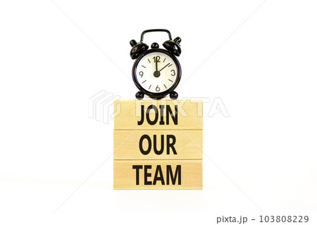 Join our team symbol. Concept words Join our team on wooden block on a beautiful white table white background. Black alarm clock. Business and join our team concept. Copy space. Join our team symbol. Concept words Join our team on wooden block on a beautiful white table white background. Black alarm clock. Business and join our team concept. Copy space. 103808229