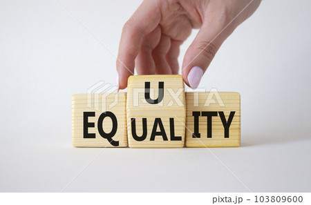 Equity and Equality symbol. Businessman hand turns wooden cubes and changes the word Equality to Equity. Beautiful white background. Equity and Equality and business concept. Copy space 103809600