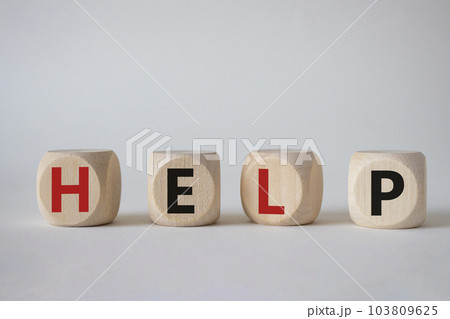 Help symbol. Concept word help on wooden cubes. Beautiful white background. Business and help concept. Copy space. Help symbol. Concept word help on wooden cubes. Beautiful white background. Business and help concept. Copy space. 103809625