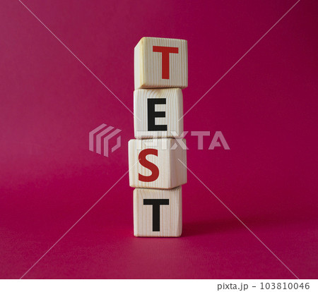 Test symbol. Concept word Test on wooden cubes. Beautiful red background. Business and Test concept. Copy space. Test symbol. Concept word Test on wooden cubes. Beautiful red background. Business and Test concept. Copy space. 103810046
