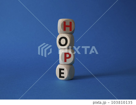 Hope symbol. Concept word Hope on wooden cubes. Beautiful blue background. Business and Hope concept. Copy space. 103810135