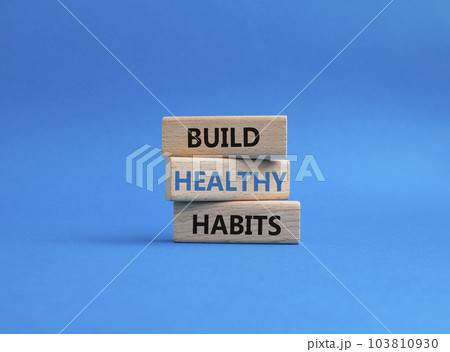 Healthy habits symbol. Concept word Build Healthy habits on wooden blocks. Beautiful blue background. Healthy lifestyle and Healthy habits concept. Copy space 103810930