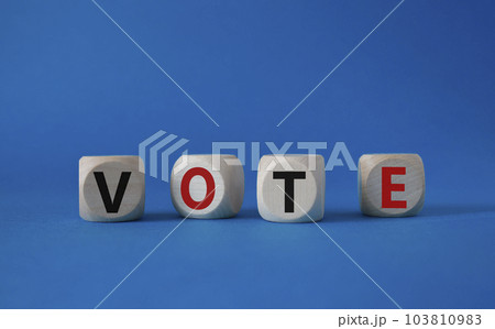 Vote symbol. Concept word Vote on wooden cubes. Beautiful blue background. Business and Vote concept. Copy space. Vote symbol. Concept word Vote on wooden cubes. Beautiful blue background. Business and Vote concept. Copy space. 103810983