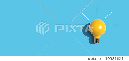 Yellow light bulb - flat lay 103816254