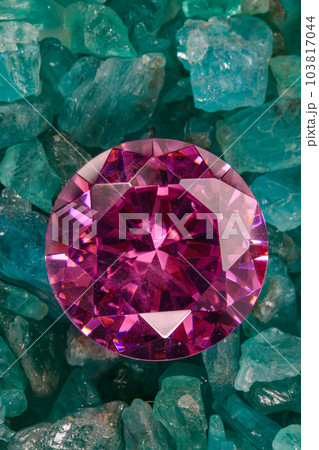 amethyst diamonds diamond on placed on a pile of raw sky blue gemstones..jewelry are lovely present for valentine day.colorful raw stone background.lived a life of luxury. 103817044