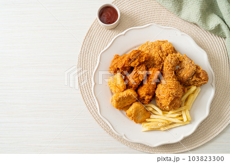fried chicken with french fries and nuggets on plate 103823300