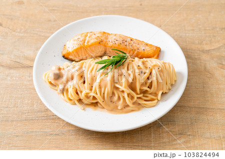grilled salmon with spaghetti creamy tomato sauce grilled salmon with spaghetti creamy tomato sauce 103824494
