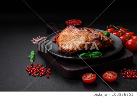 Delicious juicy pork or beef steak with salt, spices and herbs 103826253