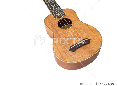 Ukulele Hawaii guitar on white background, mage from Okoume wood, Selective focus 103827899