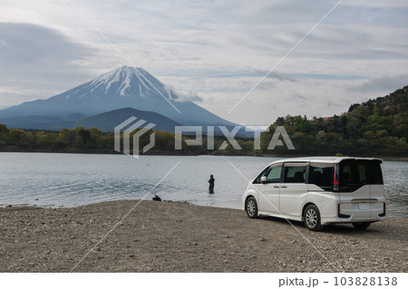 Japanese man fishing on Shoji lake by van car with mount Fuji view Japanese man fishing on Shoji lake by van car with mount Fuji view 103828138