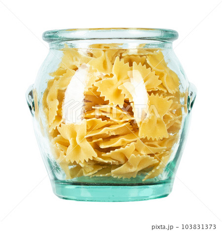 Dry Italian pasta macaroni bows farfalle in glass jar isolated on white background. Dry Italian pasta macaroni bows farfalle in glass jar isolated on white background. 103831373