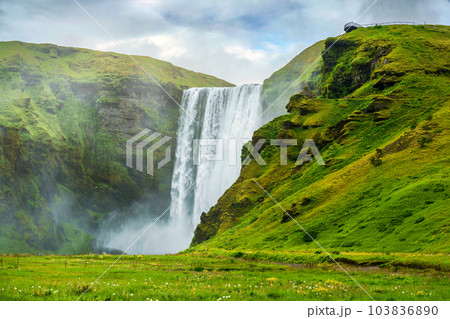 Scenery of Lush Skogafoss waterfall flowing in summer at Iceland 103836890