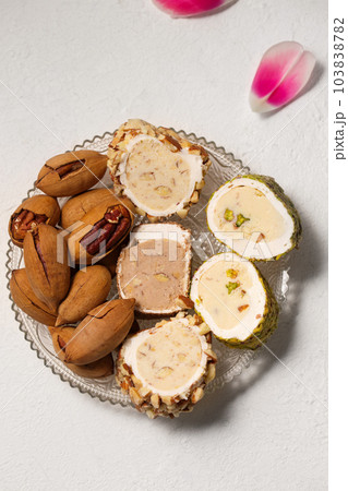 Delicious Turkish delight with pistachios and pecan nuts, top view Delicious Turkish delight with pistachios and pecan nuts, top view 103838782