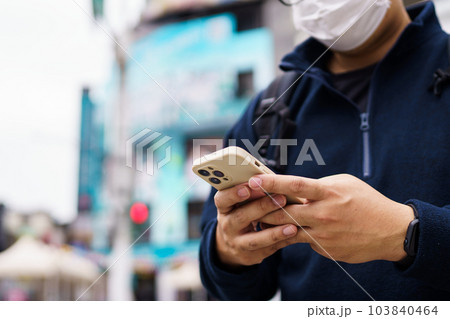 Man in downtown city street ordering taxi using smart phone app Booking taxi using application online on smart phone Man in downtown city street ordering taxi using smart phone app Booking taxi using application online on smart phone 103840464