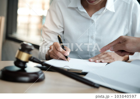 Legal counsel presents to the client a signed contract with gavel and legal law. justice and lawyer concept. Legal counsel presents to the client a signed contract with gavel and legal law. justice and lawyer concept. 103840597