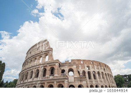 The Colosseum, an oval amphitheatre in the center of the city of Rome, Italy. It is the famous landmark built of concrete and sand. The Colosseum, an oval amphitheatre in the center of the city of Rome, Italy. It is the famous landmark built of concrete and sand. 103844914