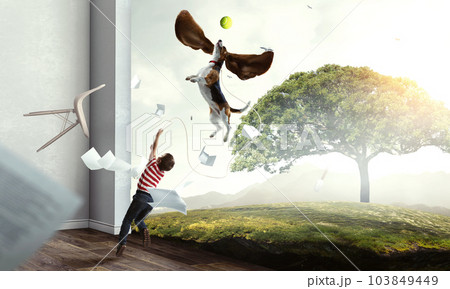 Boy with a dog flying through the air with his ears Boy with a dog flying through the air with his ears 103849449
