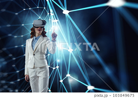 Woman wearing virtual reality goggles Woman wearing virtual reality goggles 103849675