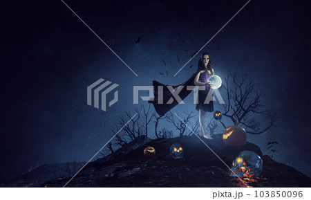 Beautiful young woman in witches hat and costume 103850096