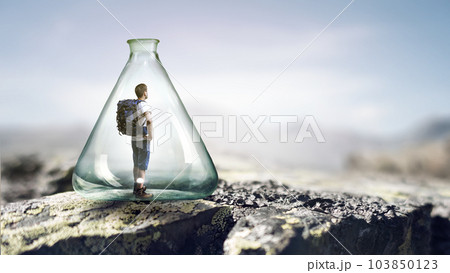 Young traveler inside glass bottle 103850123