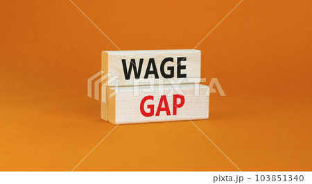 Wage gap symbol. Concept words Wage gap on wooden blocks on a beautiful orange table orange background. Business, support and wage gap concept. Copy space. Wage gap symbol. Concept words Wage gap on wooden blocks on a beautiful orange table orange background. Business, support and wage gap concept. Copy space. 103851340