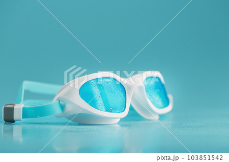 Swimming goggles in a white frame with on a blue background 103851542