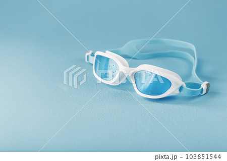 Swimming goggles in a white frame with on a blue background 103851544