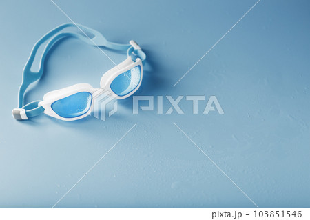 Swimming goggles in a white frame with on a blue background 103851546